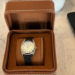 Shinola Silver Dial Watch with Black Strap.  Inspired by the bend of a horseshoe